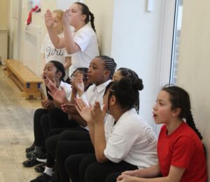 Girls and boys cheering on their peers
